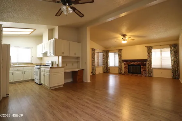 a kitchen with a refrigerator and a fireplace