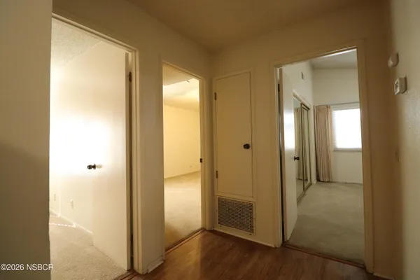 a view of a hallway with wooden floor