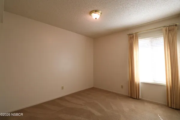 an empty room with a empty space and windows