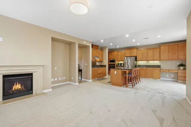 a view of a kitchen with chairs and a fireplace