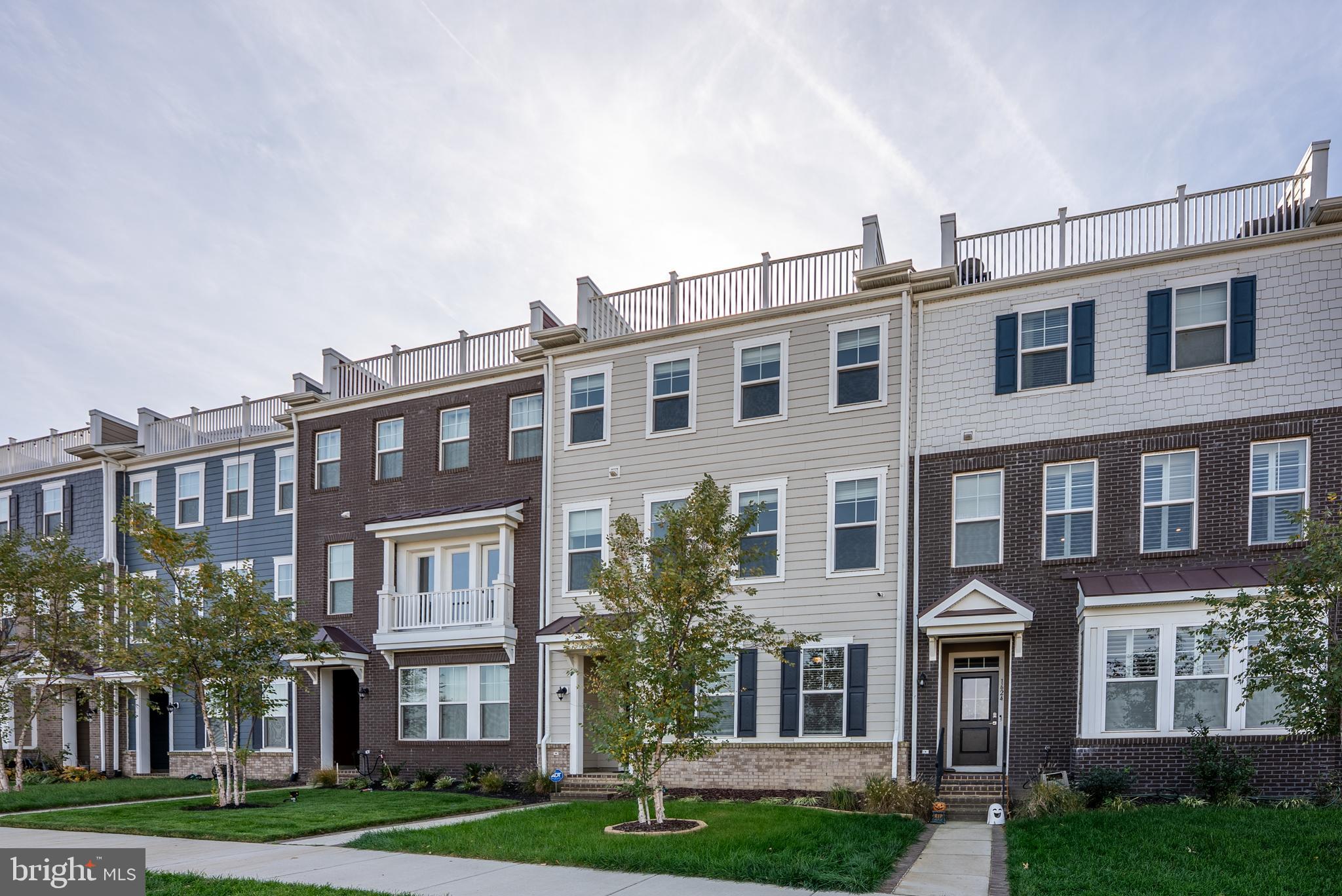 a front view of a residential apartment building with a yard