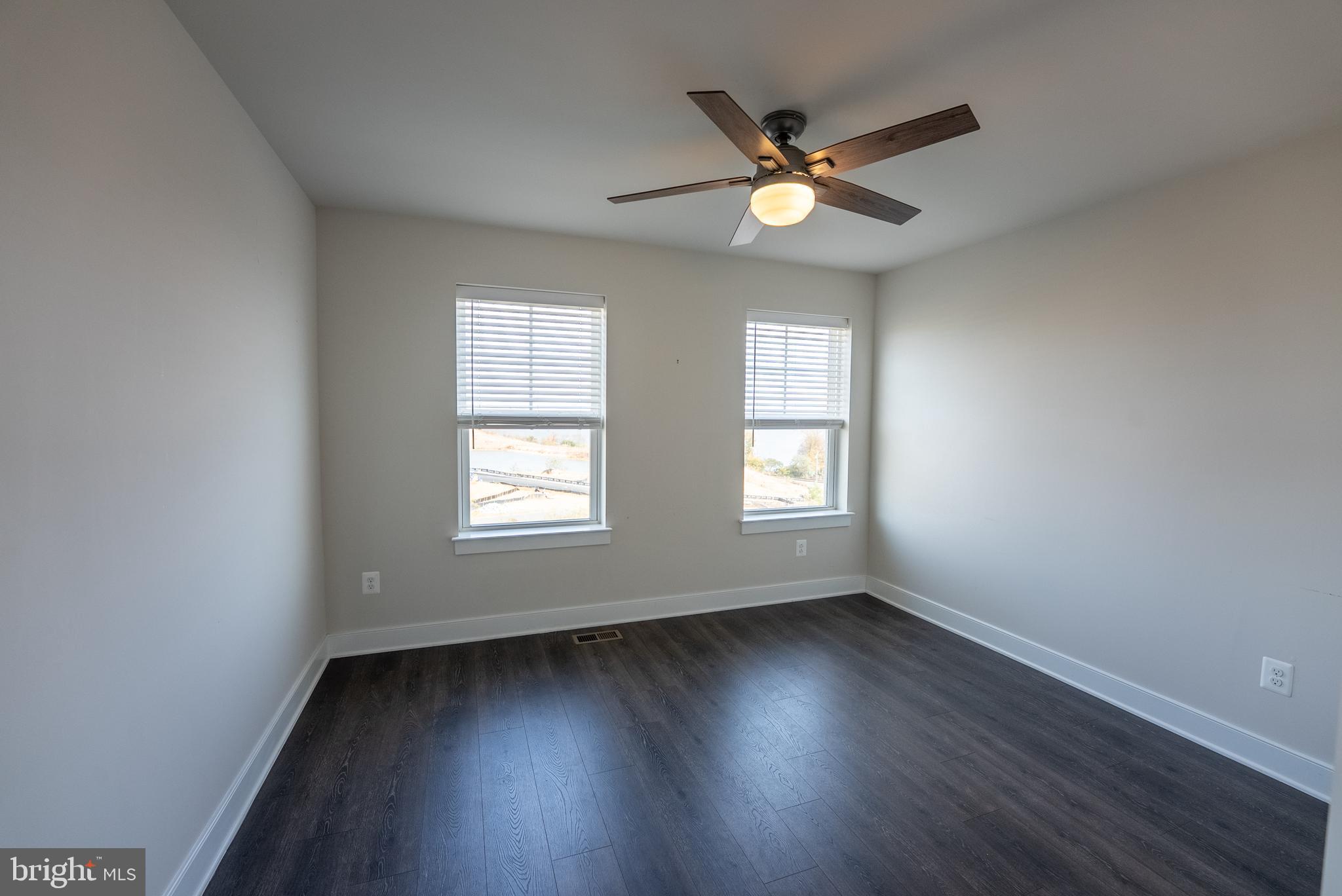 1622 Sandpiper Bay Loop Dumfries, VA 22026 - Photo 14 of 47 a view of an empty room with wooden floor and a window