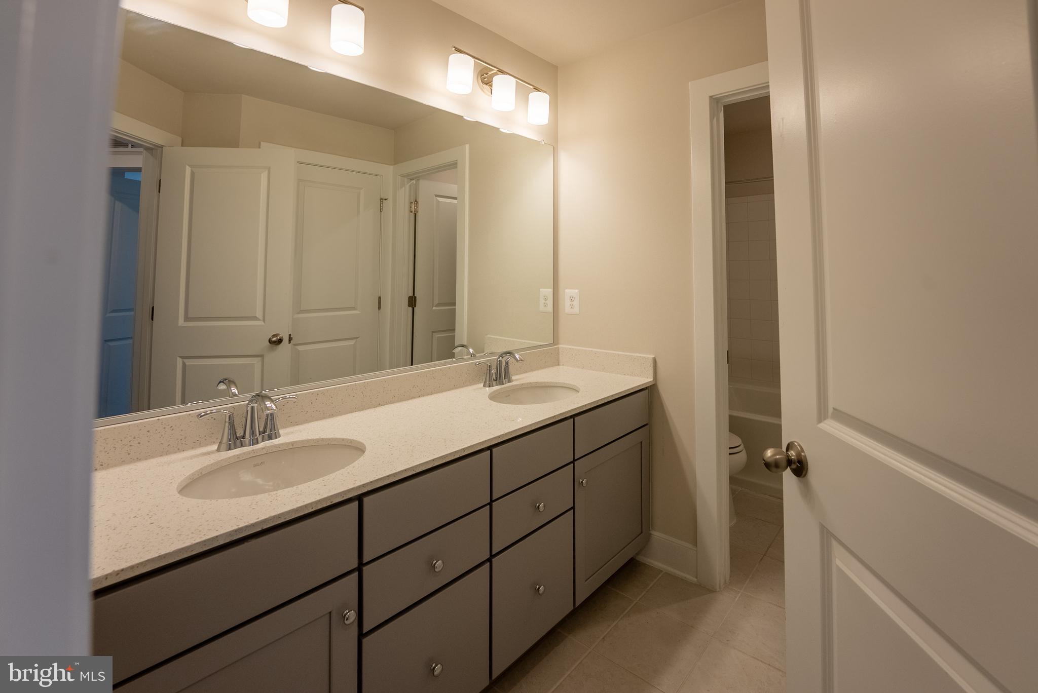 1622 Sandpiper Bay Loop Dumfries, VA 22026 - Photo 18 of 47 a bathroom with a sink and a mirror