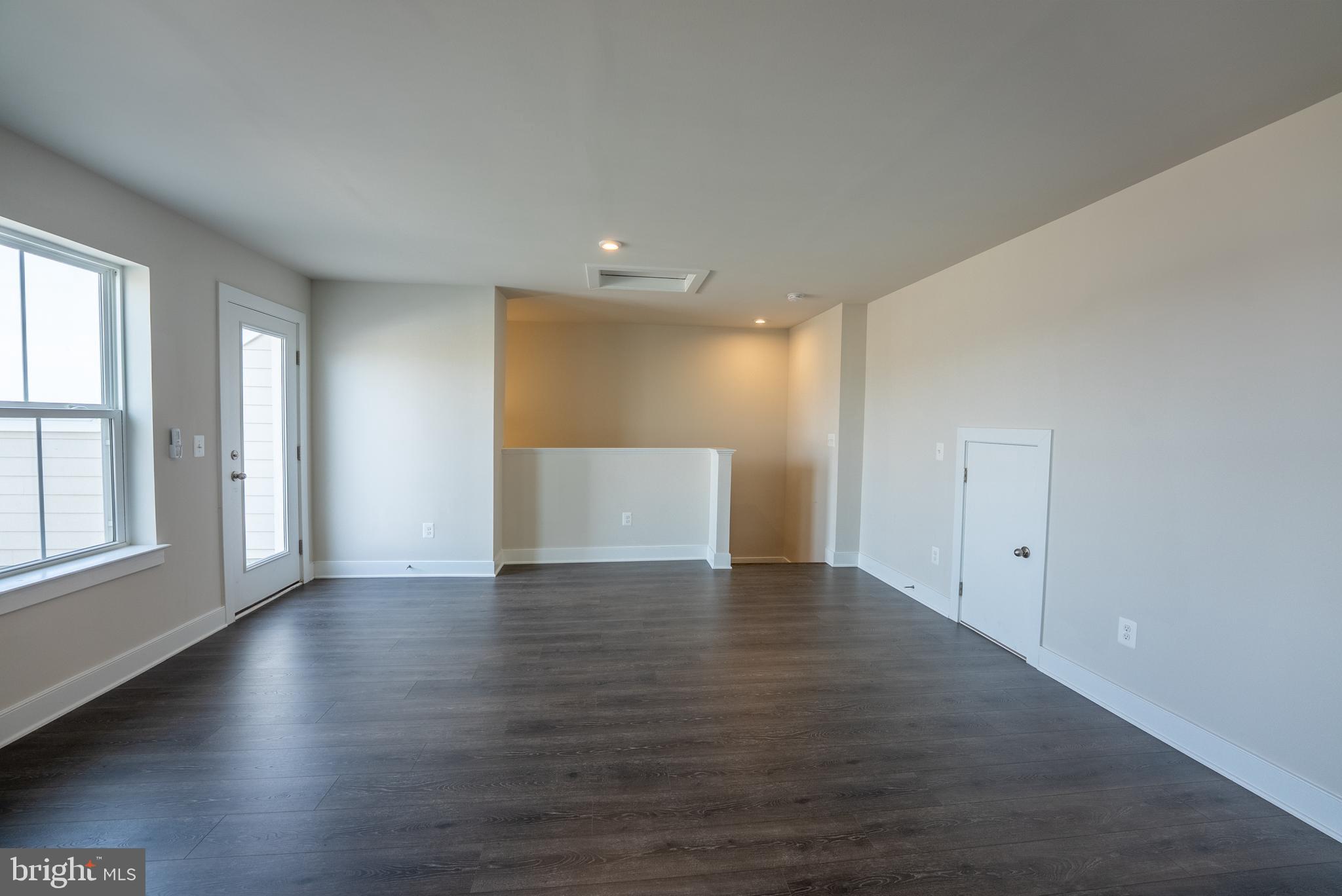 1622 Sandpiper Bay Loop Dumfries, VA 22026 - Photo 21 of 47 an empty room with wooden floor and windows