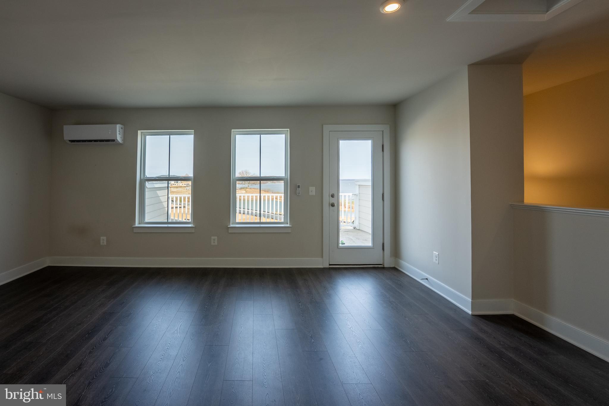 1622 Sandpiper Bay Loop Dumfries, VA 22026 - Photo 22 of 47 an empty room with wooden floor and windows