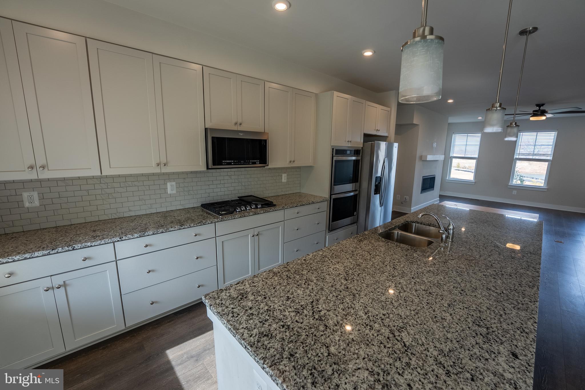 1622 Sandpiper Bay Loop Dumfries, VA 22026 - Photo 33 of 47 a kitchen with stainless steel appliances granite countertop a sink stove and refrigerator