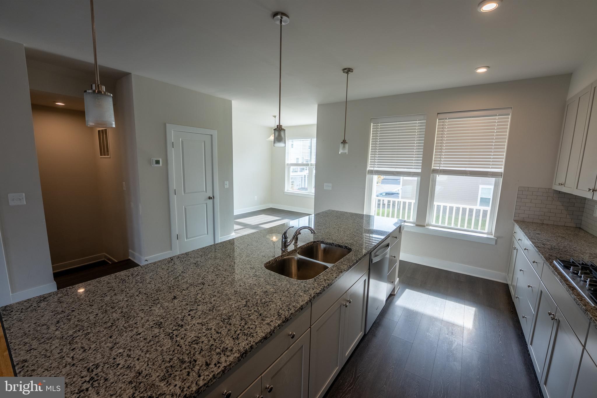 1622 Sandpiper Bay Loop Dumfries, VA 22026 - Photo 34 of 47 a kitchen with granite countertop sink and refrigerator