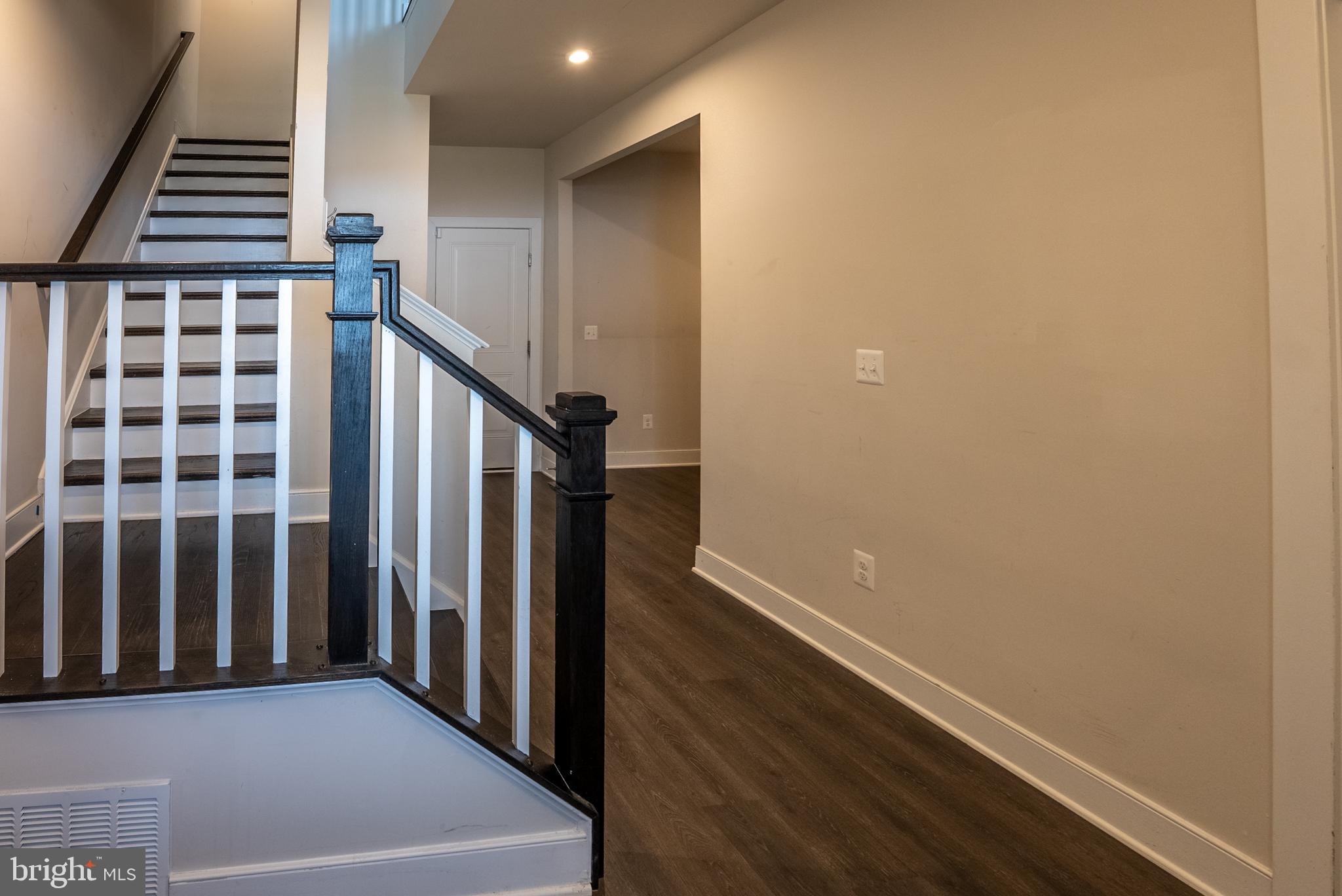 1622 Sandpiper Bay Loop Dumfries, VA 22026 - Photo 4 of 47 a view of a hallway with wooden floor and staircase