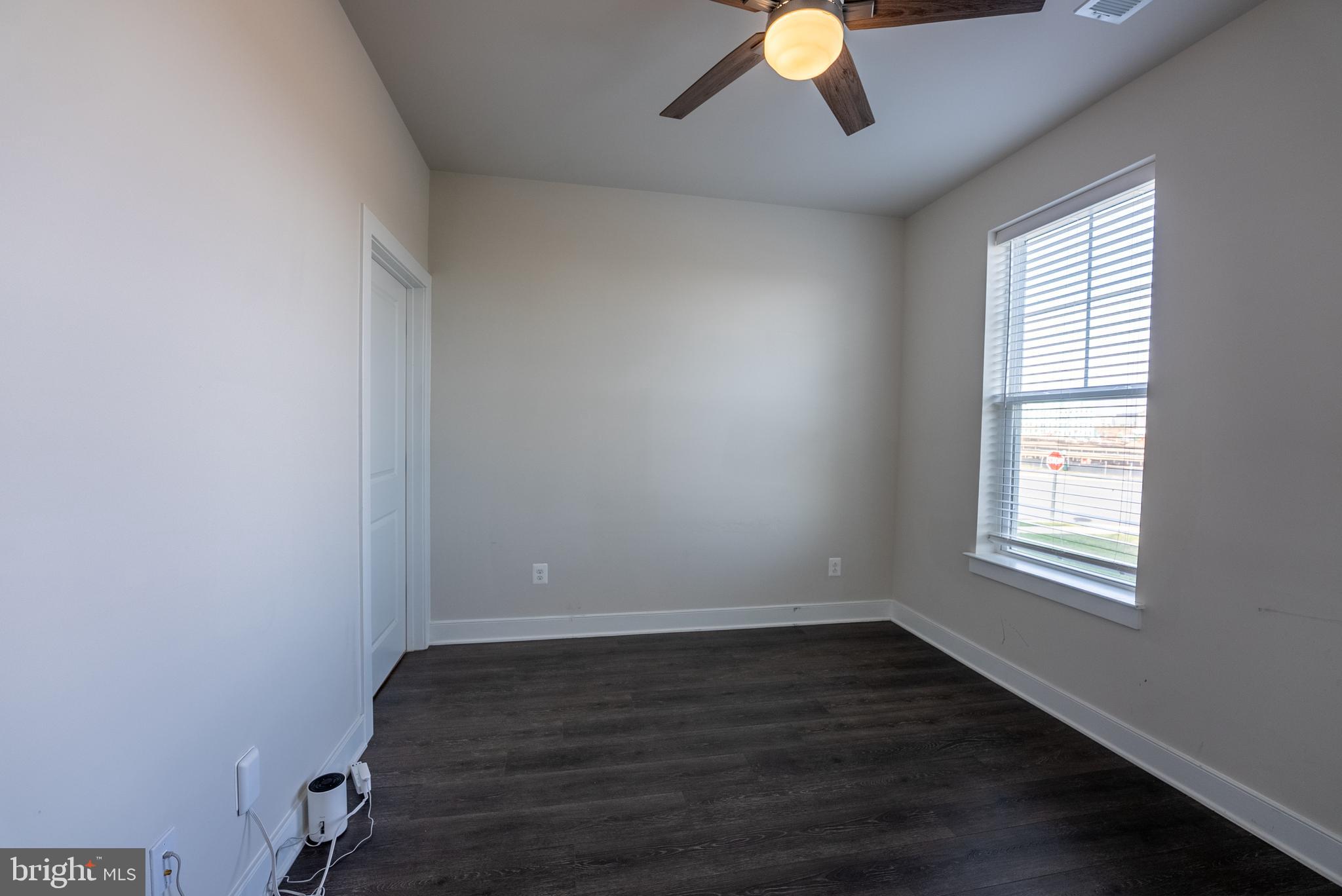 1622 Sandpiper Bay Loop Dumfries, VA 22026 - Photo 44 of 47 an empty room with wooden floor fan and windows
