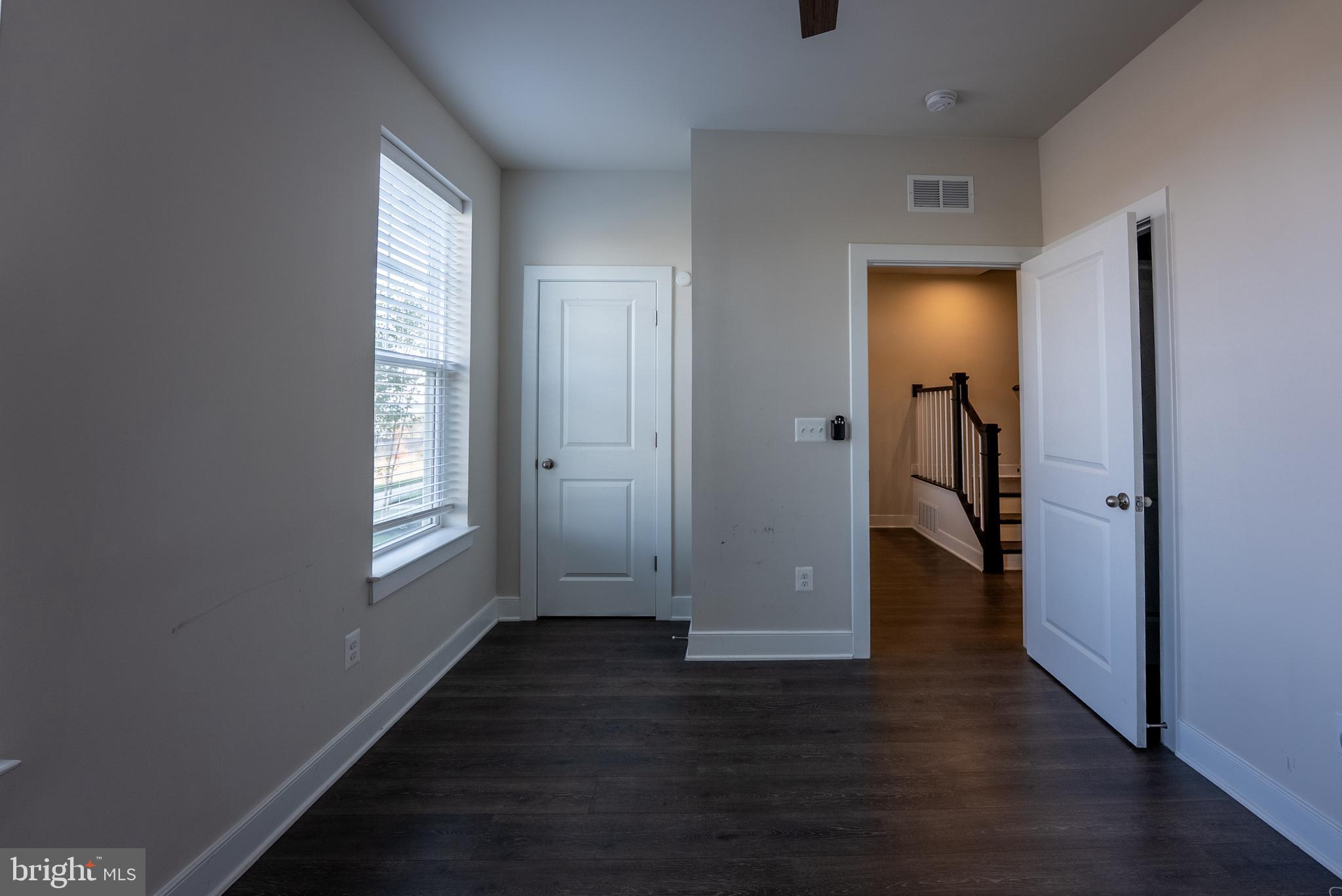 1622 Sandpiper Bay Loop Dumfries, VA 22026 - Photo 45 of 47 an empty room with wooden floor and windows