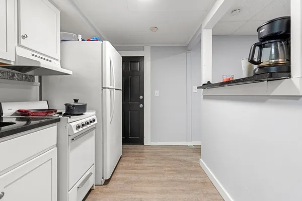 a kitchen with stainless steel appliances granite countertop a refrigerator and a stove top oven