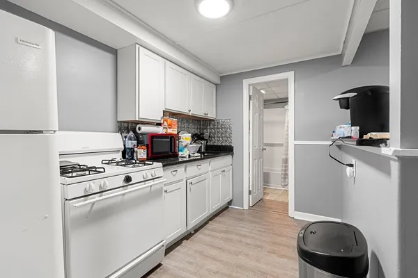 a kitchen with a stove and a refrigerator