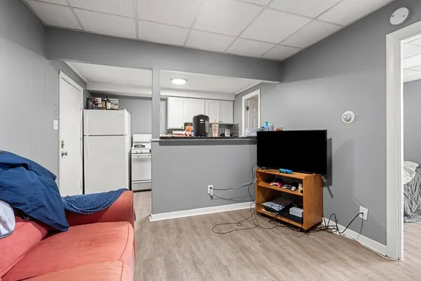 a kitchen with stainless steel appliances a refrigerator and a couch
