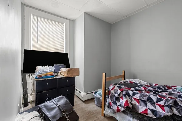 a bedroom with a bed and a window