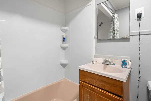 a bathroom with a sink and mirror
