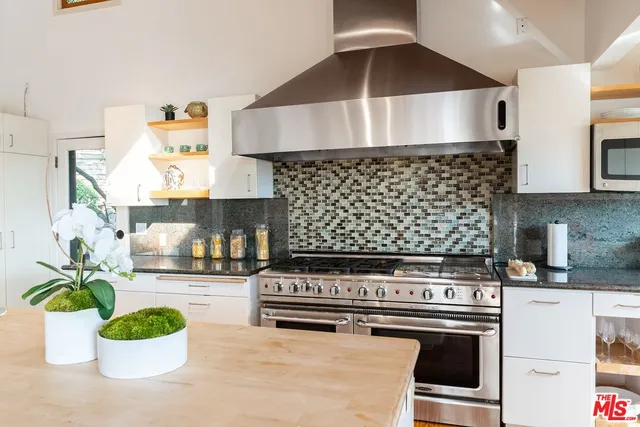 a kitchen with a stove a microwave and cabinets