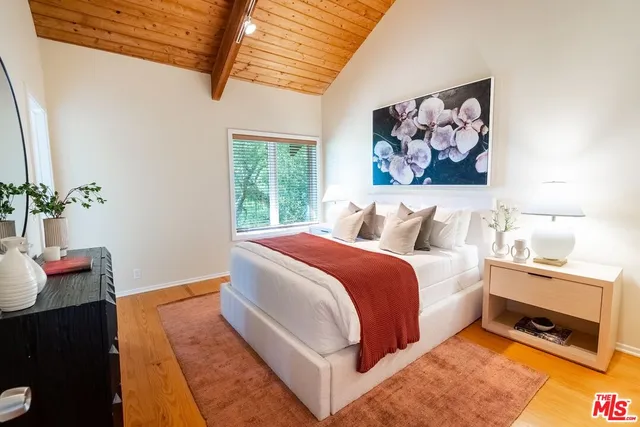 a spacious bedroom with a bed and a window