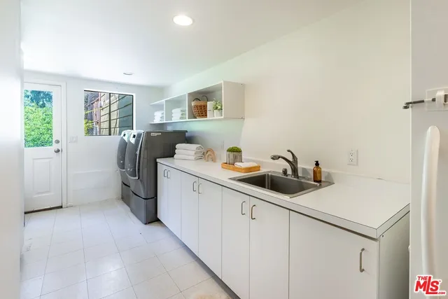 a kitchen with sink cabinets and window