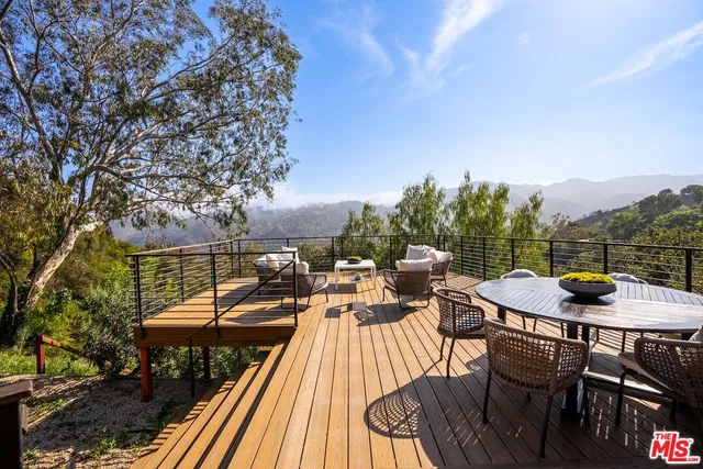 a view of a patio with table and chairs and couches