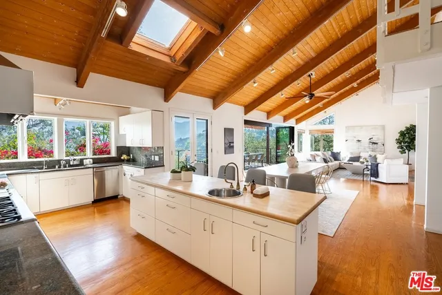 a large white kitchen with lots of counter top space