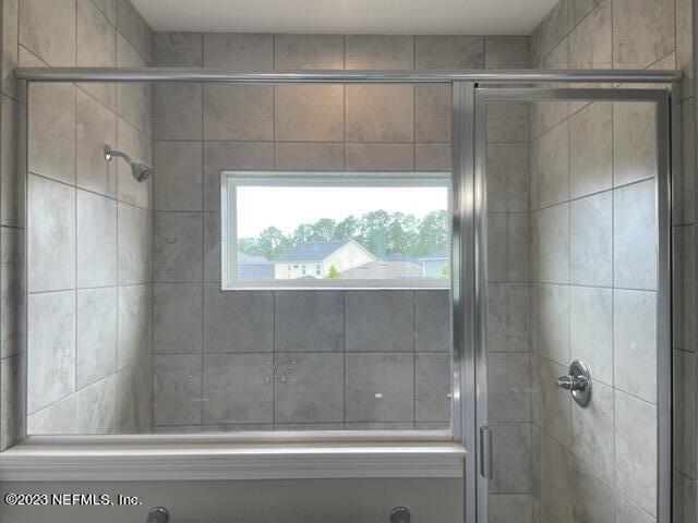 2218 Eagle Talon Circle Fleming Island, FL 32003 - Photo 19 of 40 a bathroom with a shower and a window