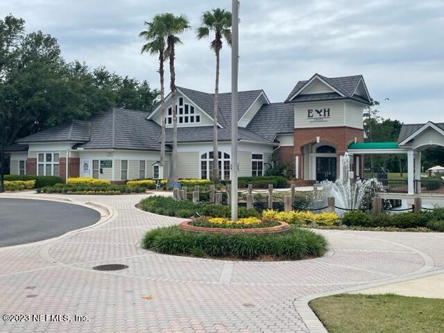 2218 Eagle Talon Circle Fleming Island, FL 32003 - Photo 29 of 40 a front view of a house with a yard and potted plants
