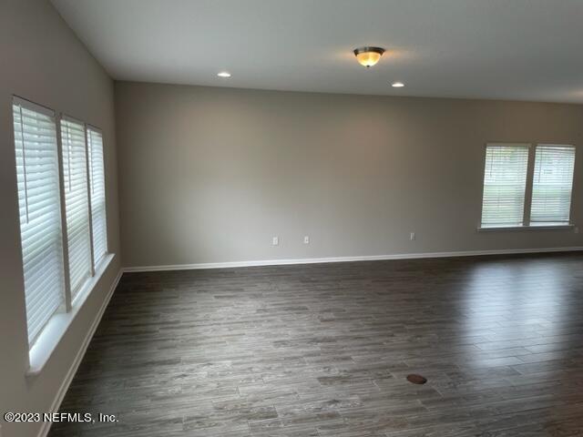 2218 Eagle Talon Circle Fleming Island, FL 32003 - Photo 31 of 40 an empty room with wooden floor and windows