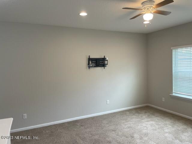 2218 Eagle Talon Circle Fleming Island, FL 32003 - Photo 32 of 40 an empty room with a window and a fan