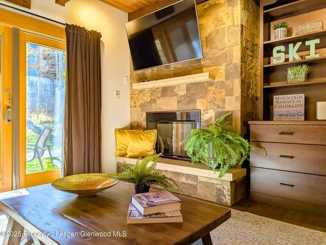 a living room with furniture and flat screen tv