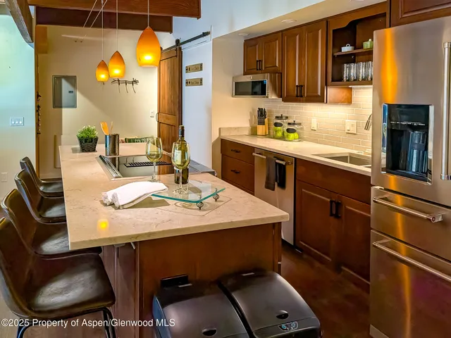 a kitchen with a sink appliances and cabinets
