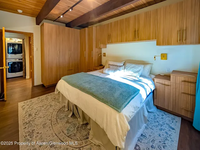 a bedroom with a bed and a mirror