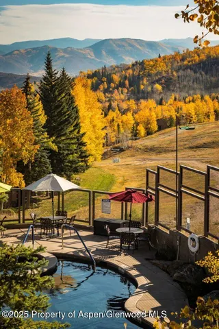 a front view of a house with swimming pool table and chairs