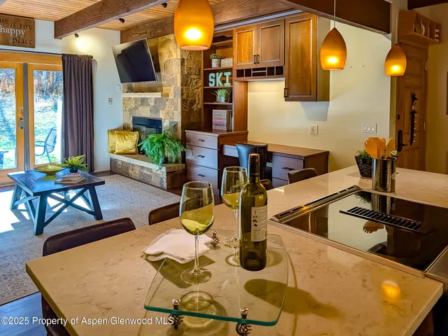 a kitchen with a table chairs and a kitchen view
