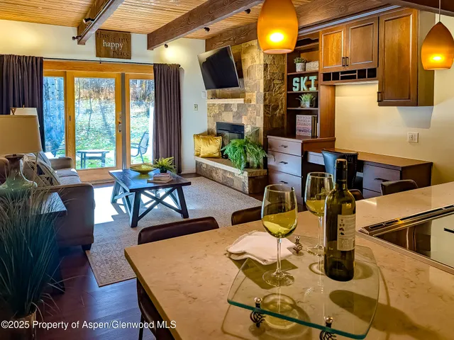 a view of a dining room with furniture a chandelier and wooden floor