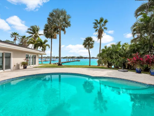 a view of a house with swimming pool and a yard