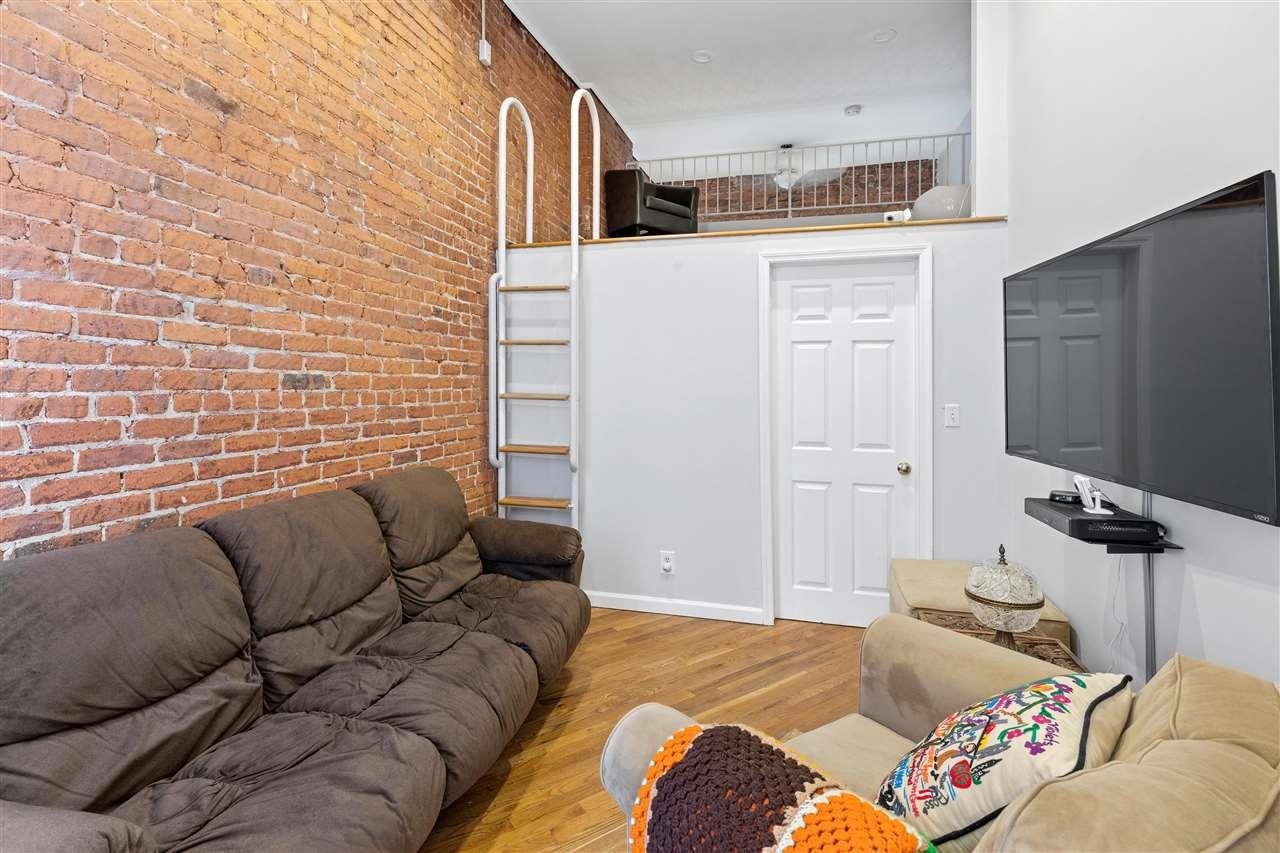 a bedroom with a bed window and couch