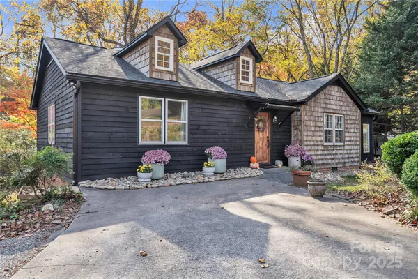 a view of a house with a patio and a yard