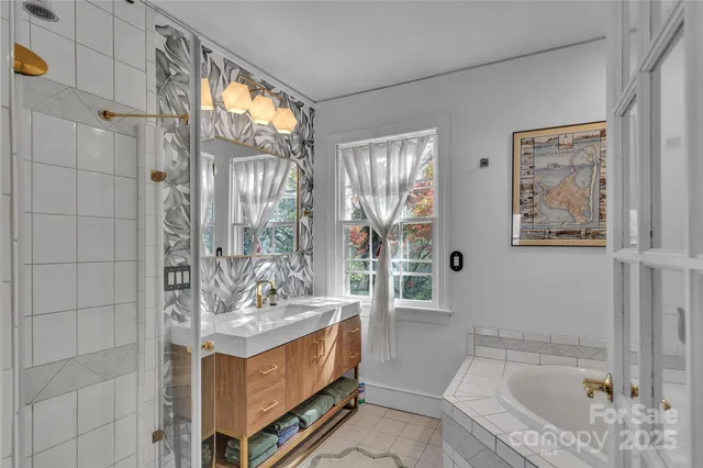 a bathroom with a tub sink and mirror
