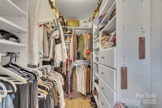 a view of a room with furniture and wooden floor