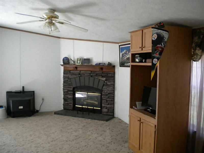 110 High Street Volant, PA 16156 - Photo 9 of 22 Other. Beautiful stone gas fireplace in room that could be either dining room or family room.