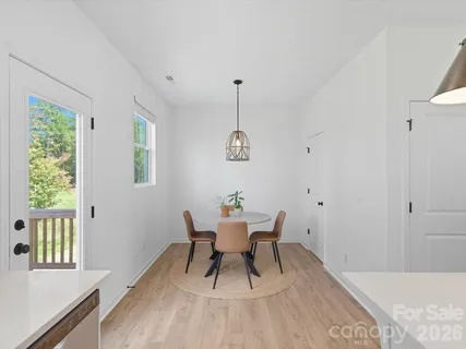 a dining room with wooden floor and a window