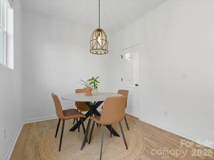 a view of a dining room with a table and chairs
