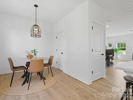 a view of a dining room with furniture wooden floor and a chandelier