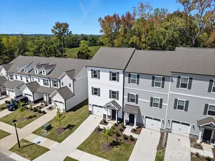 a aerial view of a residential apartment building with a yard