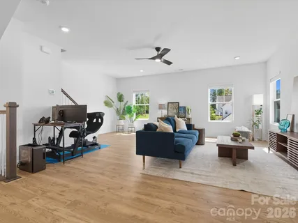 a living room with furniture and a gym machine