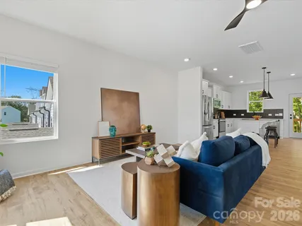 a living room with furniture and a wooden floor