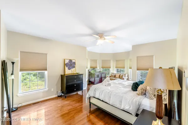 a bedroom with a bed and a flat tv screen