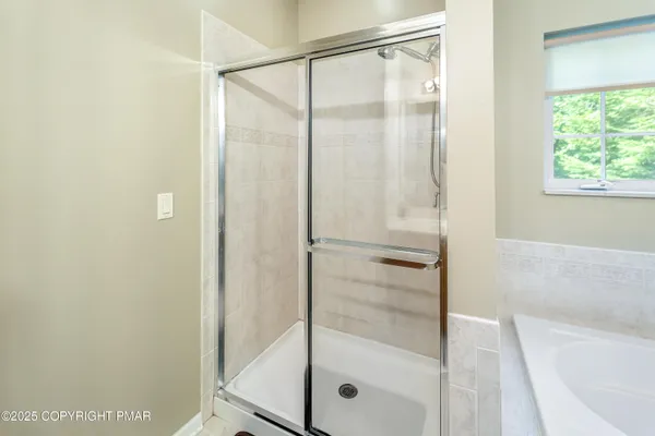 a bathroom with a glass shower door
