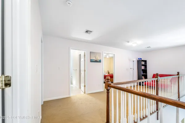 a view of a hallway with a dining room