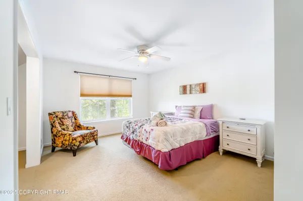 a spacious bedroom with a bed and a chandelier